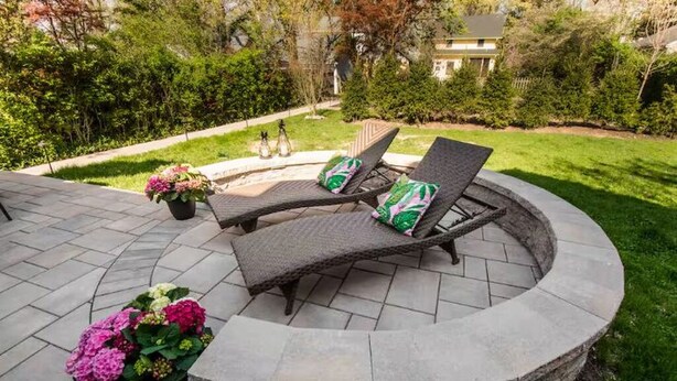 A circular stone patio with two lounge chairs and a potted plant. - Downtown Oasis Second-Floor Condo (Princeton)