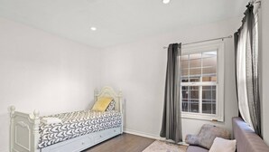 A bedroom with a bed, a sofa, a window, and a view of the outside. - Beverly Hills Home Guest House & Hot Tub (Beverly Hills)
