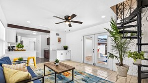 A modern living room with a sofa, coffee table, and potted plants. - Pool Oasis -Near RJ Stadium, Hyde Park & Downtown (Tampa)