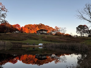 A lakeside property with a house, dock, and surrounding trees.
