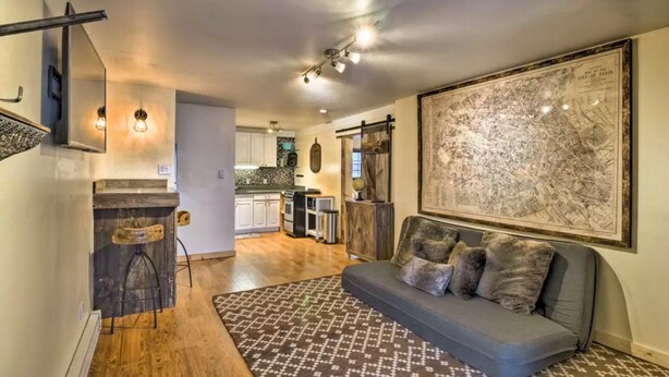 A modern kitchen with a bar area, a dining table, and a large map on the wall. - BEST LOCATION! Cozy condo on Main Street. Walk to gondola. (Breckenridge)