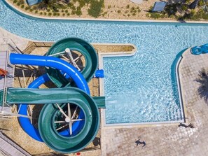 An aerial view of a swimming pool with two large water slides. - LAKEVIEW Themed Home w/ Pool & Theater Near Disney (3033) (Kissimmee)