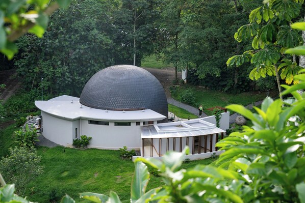 A modern building with a large dome structure, surrounded by lush greenery. - The Vessyl Experience AKEN SOUL (Monterrey)
