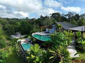 A private villa with a swimming pool, a covered outdoor seating area, and lush greenery surrounding the property. - The Vessyl Experience AKEN SOUL (Monterrey)