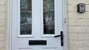 A white door with two glass panels and a black handle. - Costa Home Middlesbrough (Middlesbrough)