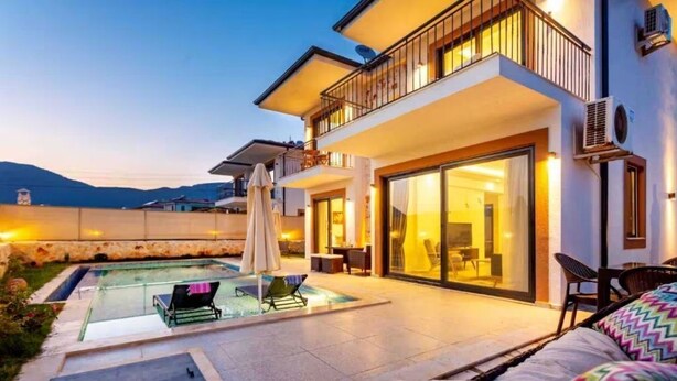 A modern two-story house with a swimming pool, outdoor seating, and a balcony. - Holiday villa in Kaş / Antalya, on the most turquoise sea of the Mediterranean. (Antalya)