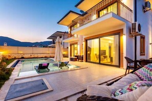 A modern two-story house with a swimming pool, outdoor seating, and a balcony. - Holiday villa in Kaş / Antalya, on the most turquoise sea of the Mediterranean. (Antalya)