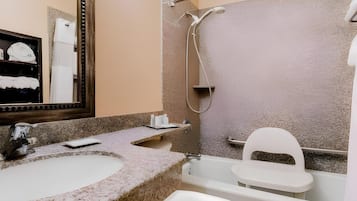 A bathroom with a sink, toilet, and bathtub.