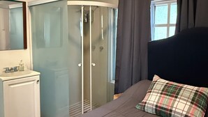 A bedroom with a bed, a wardrobe, a mirror, and a window with curtains. - The 222 (Mexico City)