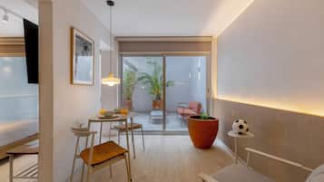 Luxury Studio, Patio | Living area | 50-inch Smart TV with digital channels