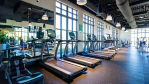 A gym with treadmills, exercise bikes, and other fitness equipment. - Chic 4BR With Pool Game Room Mickey Rooms (Kissimmee)