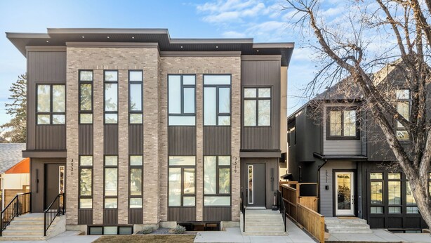 A modern two-story residential building with a flat roof, large windows, and a visible front door. - Modern, spacious 2BR suite in Calgary, 13 min to downtown, private entrance (Calgary)