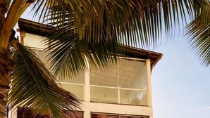 A two-story building with a beach-themed restaurant sign, large windows, and a red-tiled roof. - Pousada Recanto Paradise  (Ipojuca)