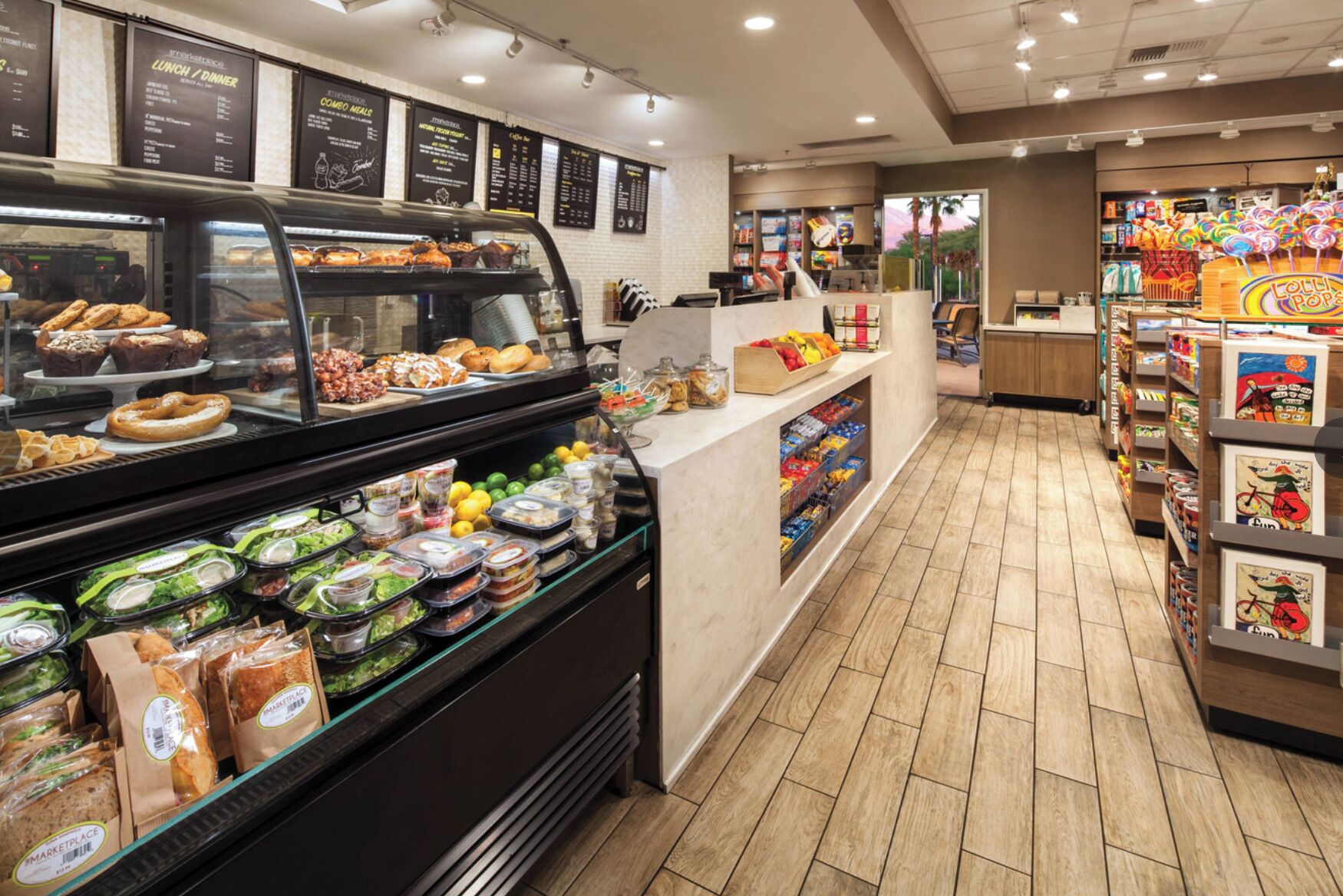 A bakery display with various baked goods, a deli counter with prepared food, and a candy section.