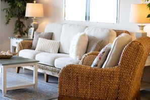 A living room with a sofa, armchair, coffee table, and lamps. - Oceanfront Condo With Private Balcony & Heated Pool! 🏝️☀️ (Cape Canaveral)