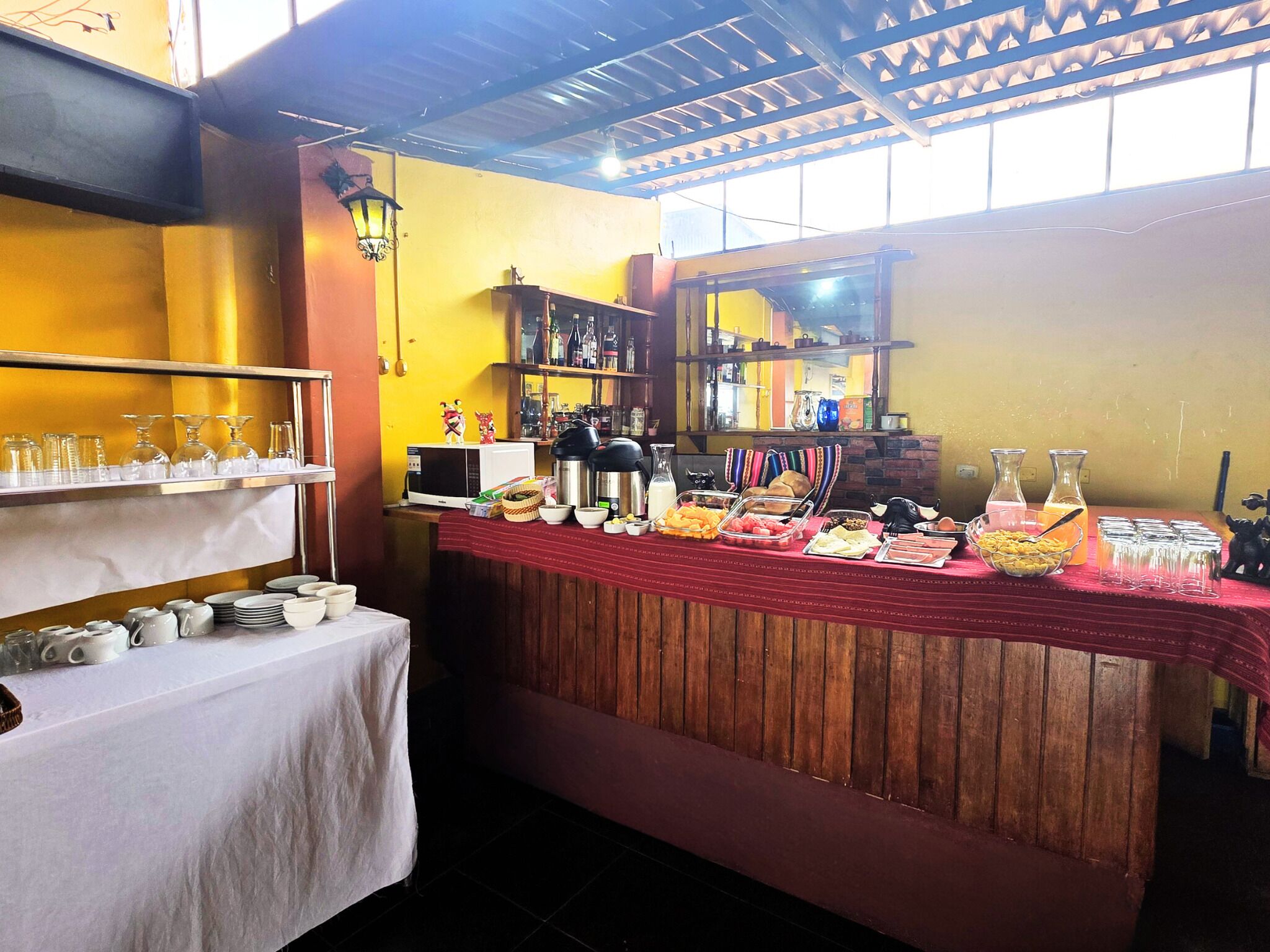 A breakfast buffet setup with various food items and glassware.