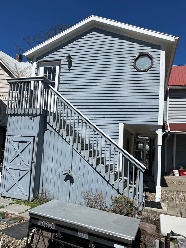 A two-story house with a front porch, a staircase, and a garage.