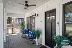 A porch with two rocking chairs, a ceiling fan, and a door marked with the number 211. - Spacious Home w/Hot Tub, Quick Walk to Fontana Nightlife, Marina, Dining, & Abbey Resort (Fontana-on-Geneva Lake)