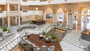 A spacious atrium with multiple levels, a central seating area with modern furniture, and a water feature. - Cabo San Lucas oceanfront getaway with resort amenities (Cabo San Lucas)