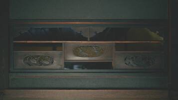 A wooden cabinet with intricate carvings and a central decorative panel.