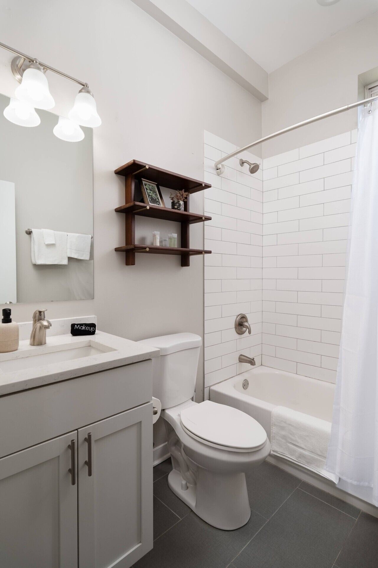 Un baño moderno con inodoro, lavamanos y ducha.