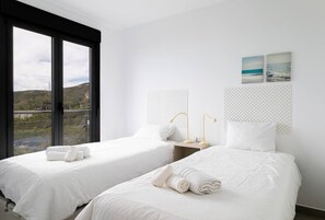 A hotel room with two beds, a large window, and a view of the landscape. - Balcon del Mar - 2 bedroom - Nerja (Nerja)