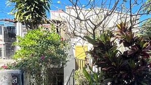 A residential area with a paved pathway, a gate with a number, and various plants. - Oceanfront Villa-Stunning Sunsets ! (Aguacate)