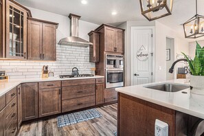 Fridge, microwave, oven, stovetop - 5 Bedroom house with amenities galore! Oversized hot tub, outdoor fire pit, smoker and propane grill, sauna, play set, espresso machine, air hockey table, indoor fireplace in both living rooms, and legacy bar. (Colorado Springs)