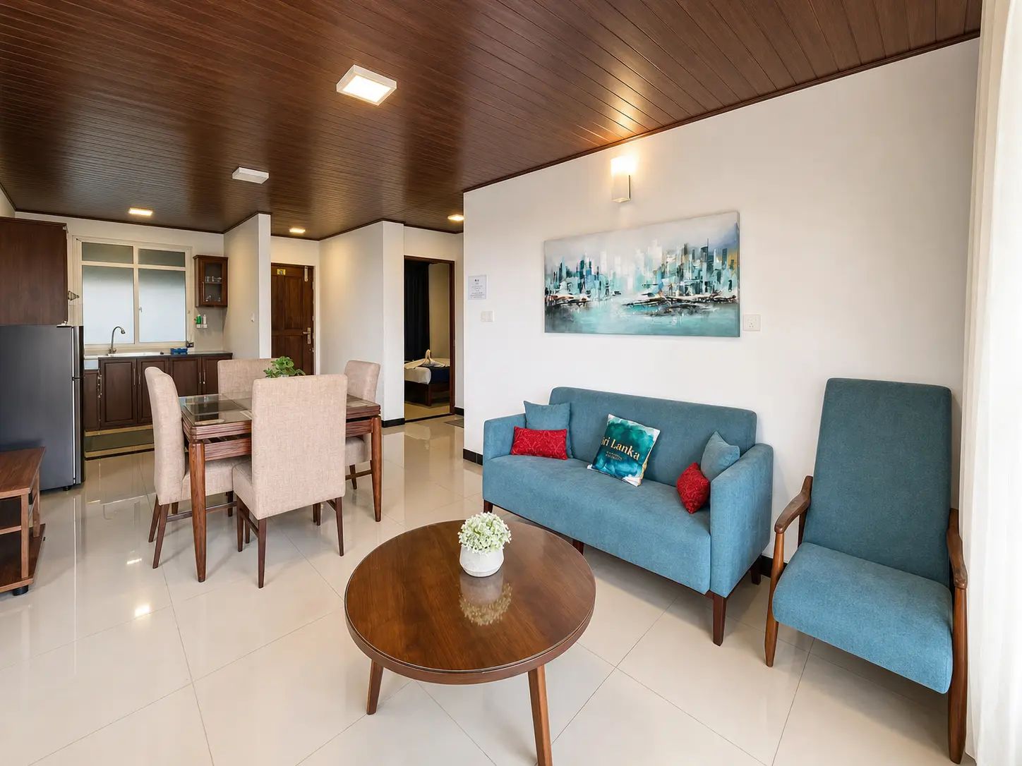 A modern living room with a blue sofa, a wooden coffee table, and a dining area with a table and chairs.