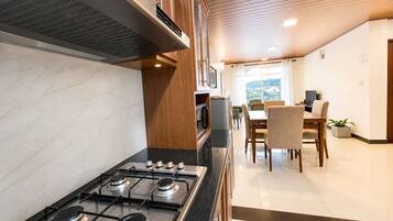 Una cocina moderna con estufa a gas, microondas y armarios de madera.