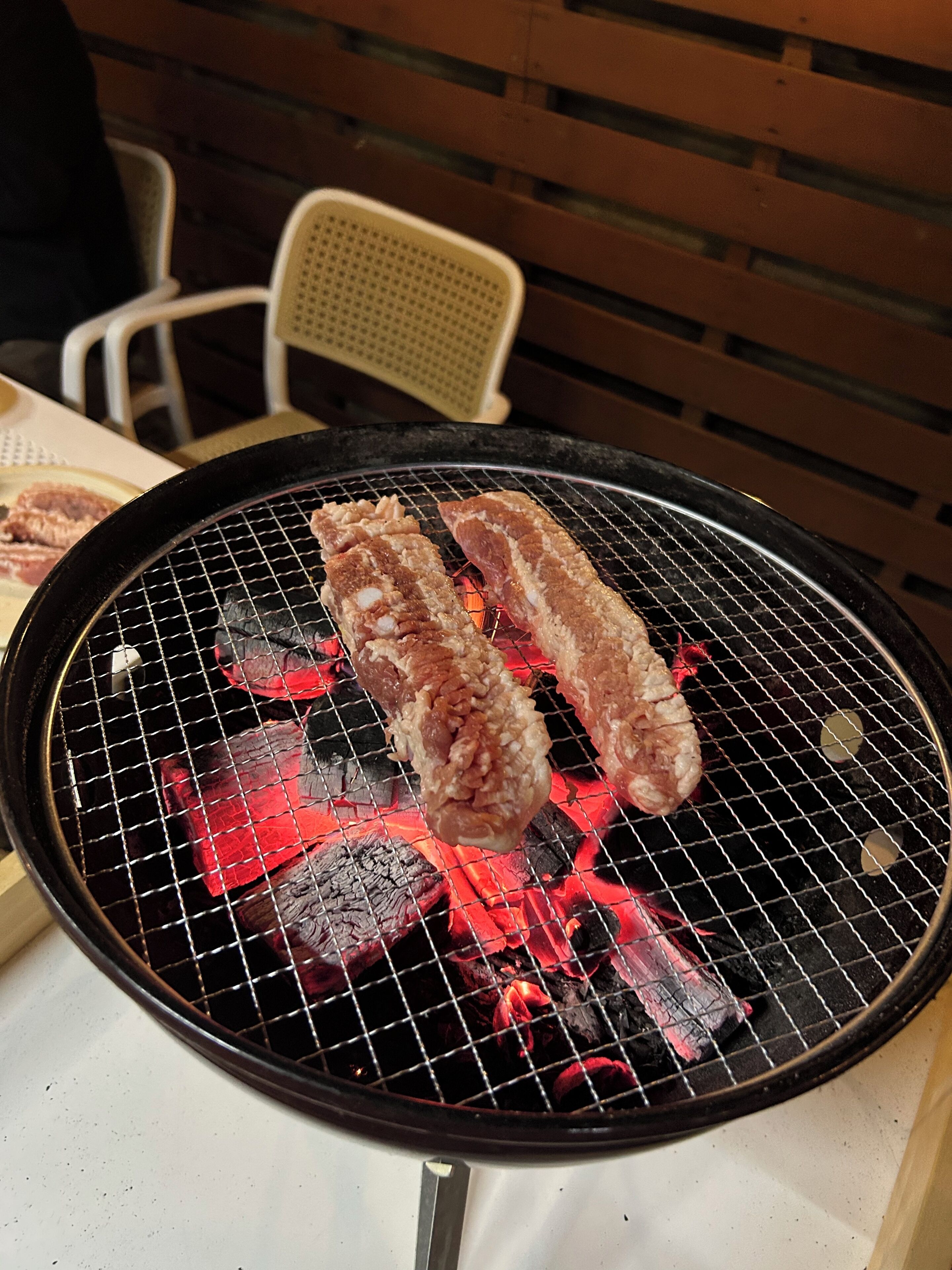 A grill with meat being cooked.