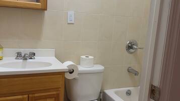 A bathroom with a sink, toilet, and bathtub.