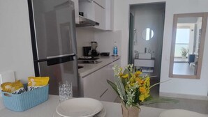 A modern kitchen with a stainless steel refrigerator, a coffee maker, and a basket of snacks. - Azul infinite... apartasuit in beautiful Cartagena (Cartagena de Indias)