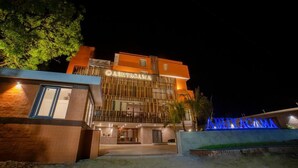 A hotel with a modern facade, a prominent sign, and a well-lit entrance. - Abhyagama Hotel (Digha)