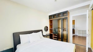 A bedroom with a bed, a nightstand, a wardrobe, and a mirror. - Sunflower Home - Scenic Valley 2 (Ho Chi Minh City)
