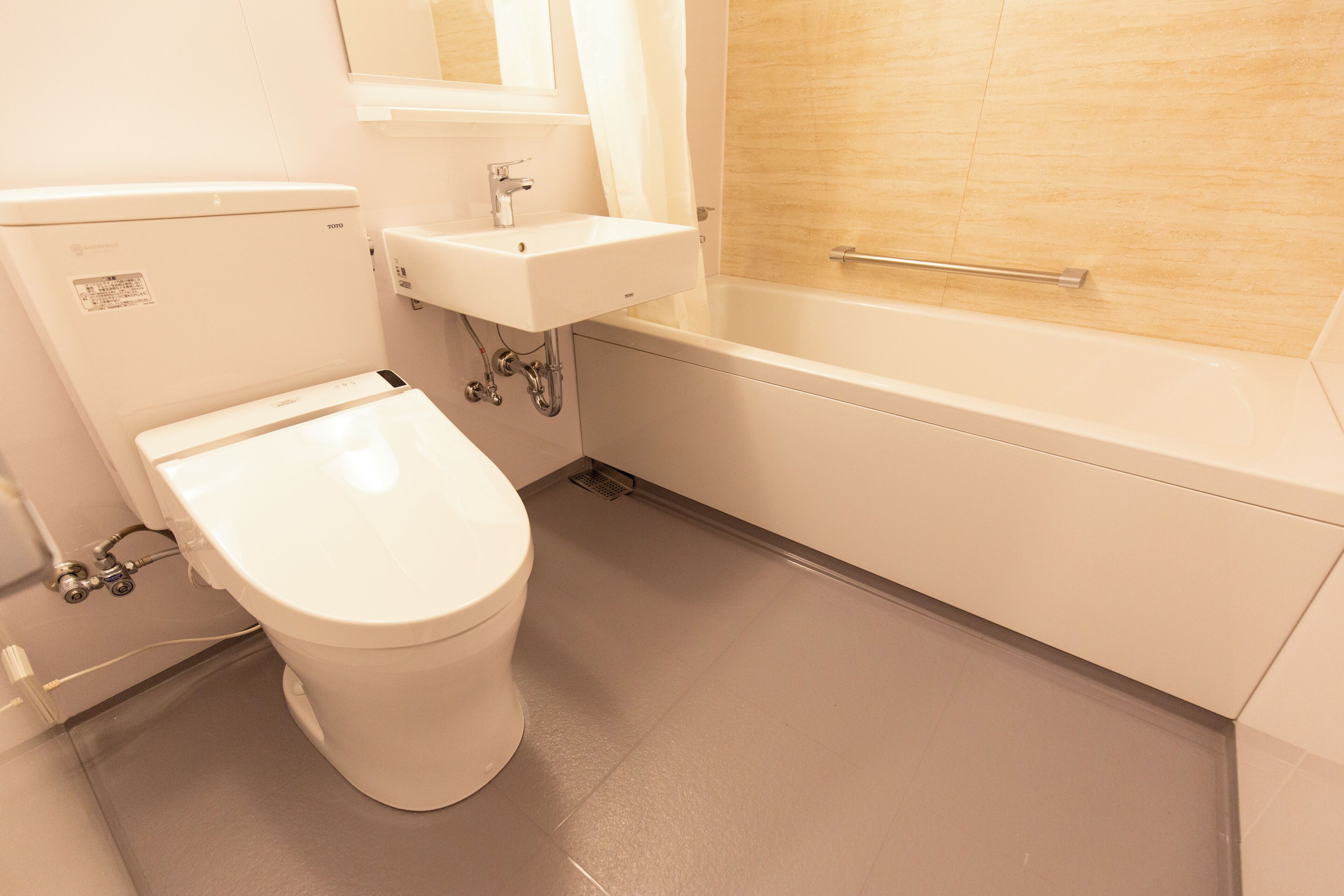Separate bathtub and shower, towels, shampoo, toilet paper