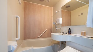 A modern bathroom with a bathtub, a sink, and a toilet.