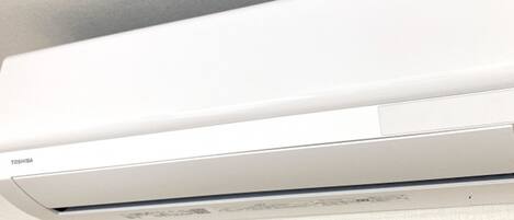 A white air conditioning unit mounted on a wall.