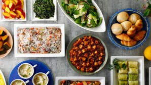 A variety of dishes including a salad, a noodle dish, and several types of soup.