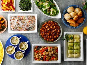 A variety of dishes including a salad, a noodle dish, and several types of soup.