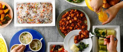 A table with various dishes and food items.