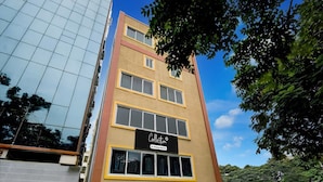 A multi-story building with a sign reading 'Collection & Company Service.' - Hotel O Kakatiya Hills Shree Adithya Luxury (Hyderabad)