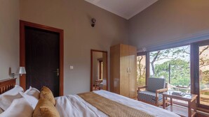 A bedroom with a bed, a wardrobe, a desk, and a chair. - Alaya Stays Amara Aether (Naina Range)