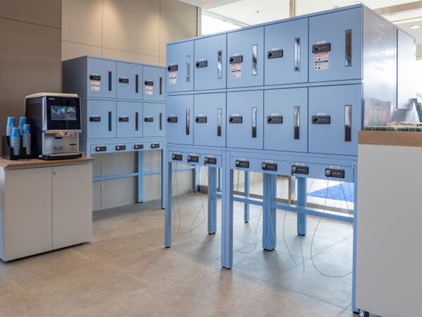 A modern office with blue filing cabinets, a coffee machine, and a computer monitor. - Toyoko Inn Ube-Shinkawa-eki (Ube)