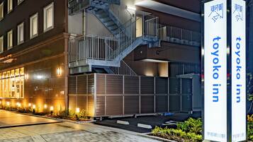 A building with a staircase and a sign for Toyoko Inn.