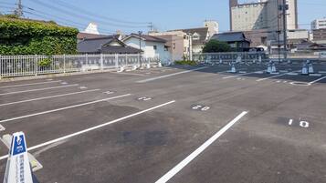 A parking lot with clearly marked spaces and a hotel entrance.