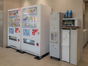 Two beverage vending machines and a microwave oven in a commercial setting. - Toyoko Inn Ube-Shinkawa-eki (Ube)