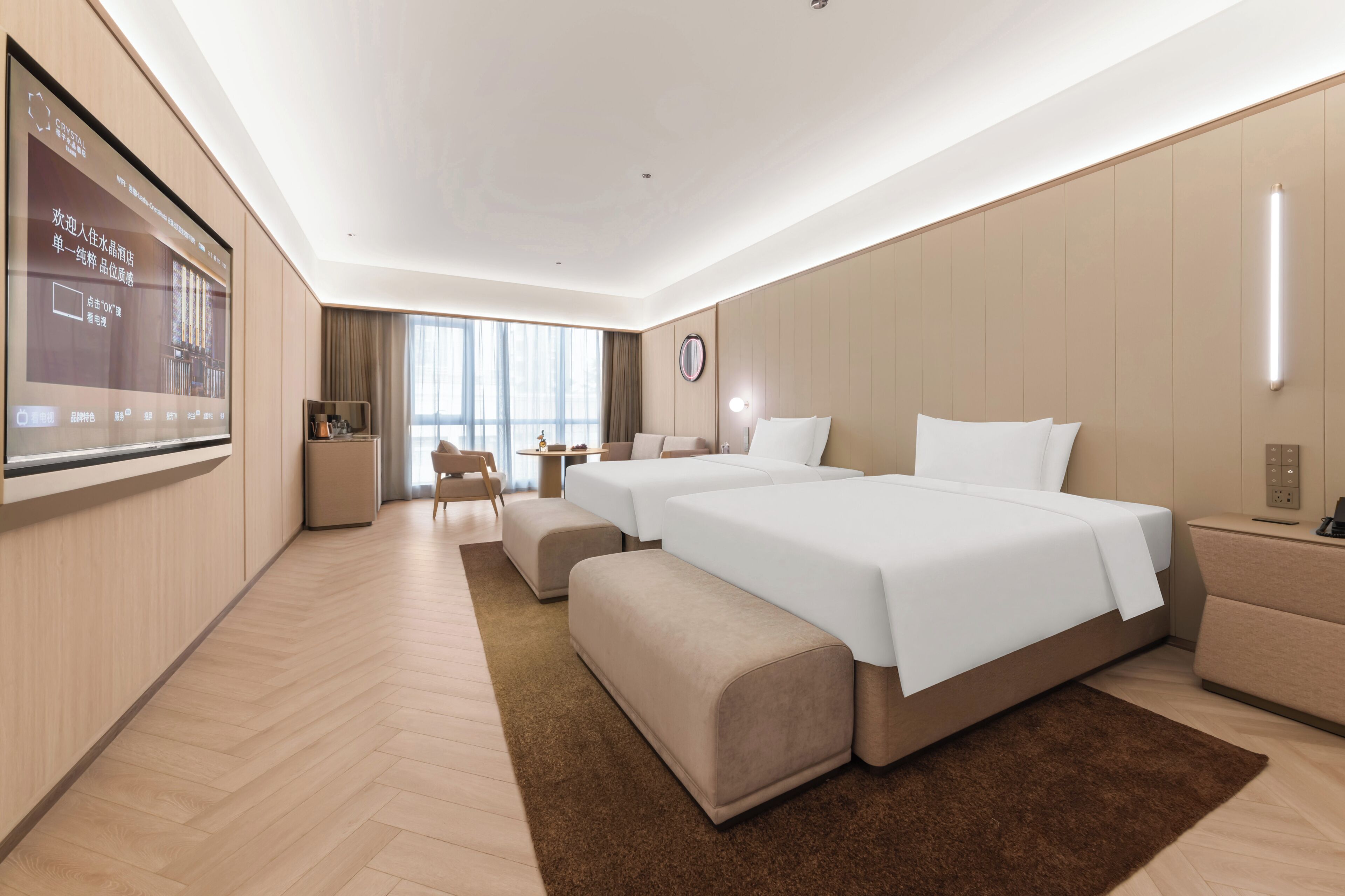 Een moderne hotelkamer met een groot bed, een bureau, een stoel en een televisiescherm.
