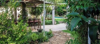 Arty Guesthouse nestled in a tranquil garden with calming birdlife.