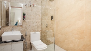 A bathroom with a sink, toilet, and shower. - Alpine Retreat (Rishikesh)